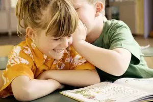 A boy and a girl having fun while learning